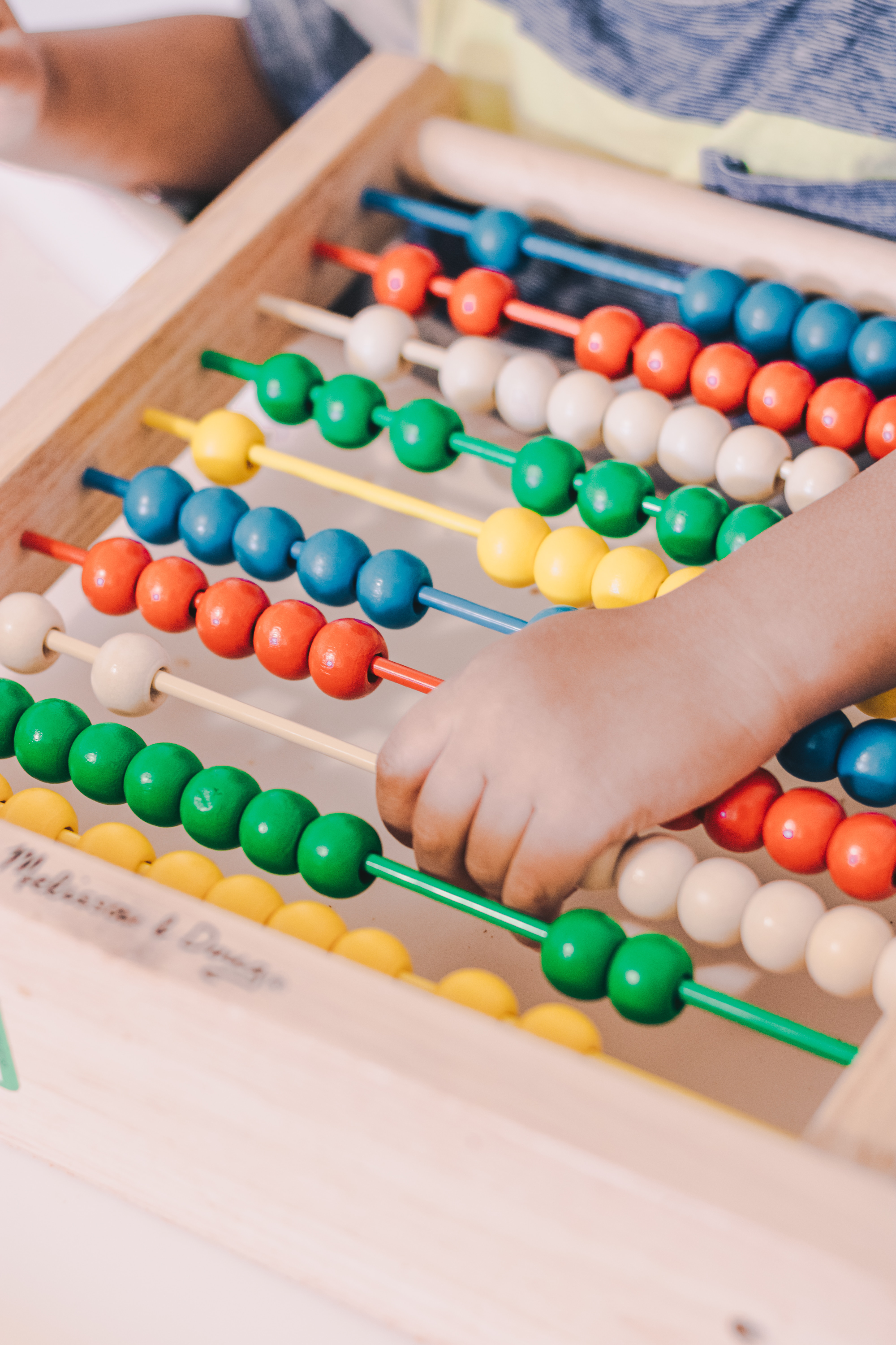 Child using colourful learning tools during therapy